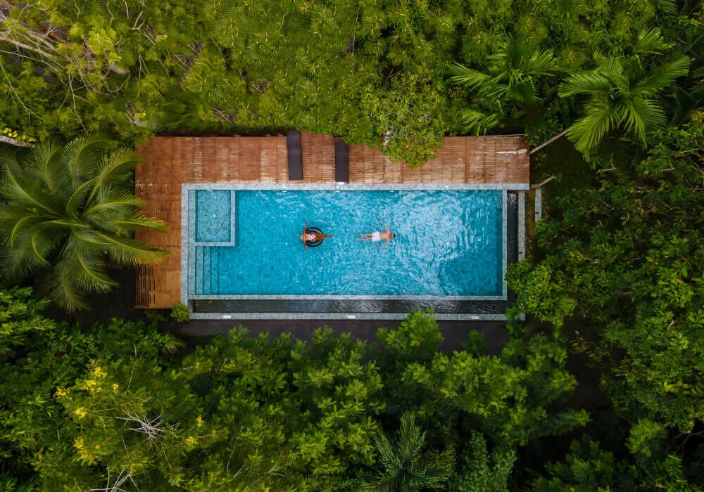 Couple swimming luxurious pool