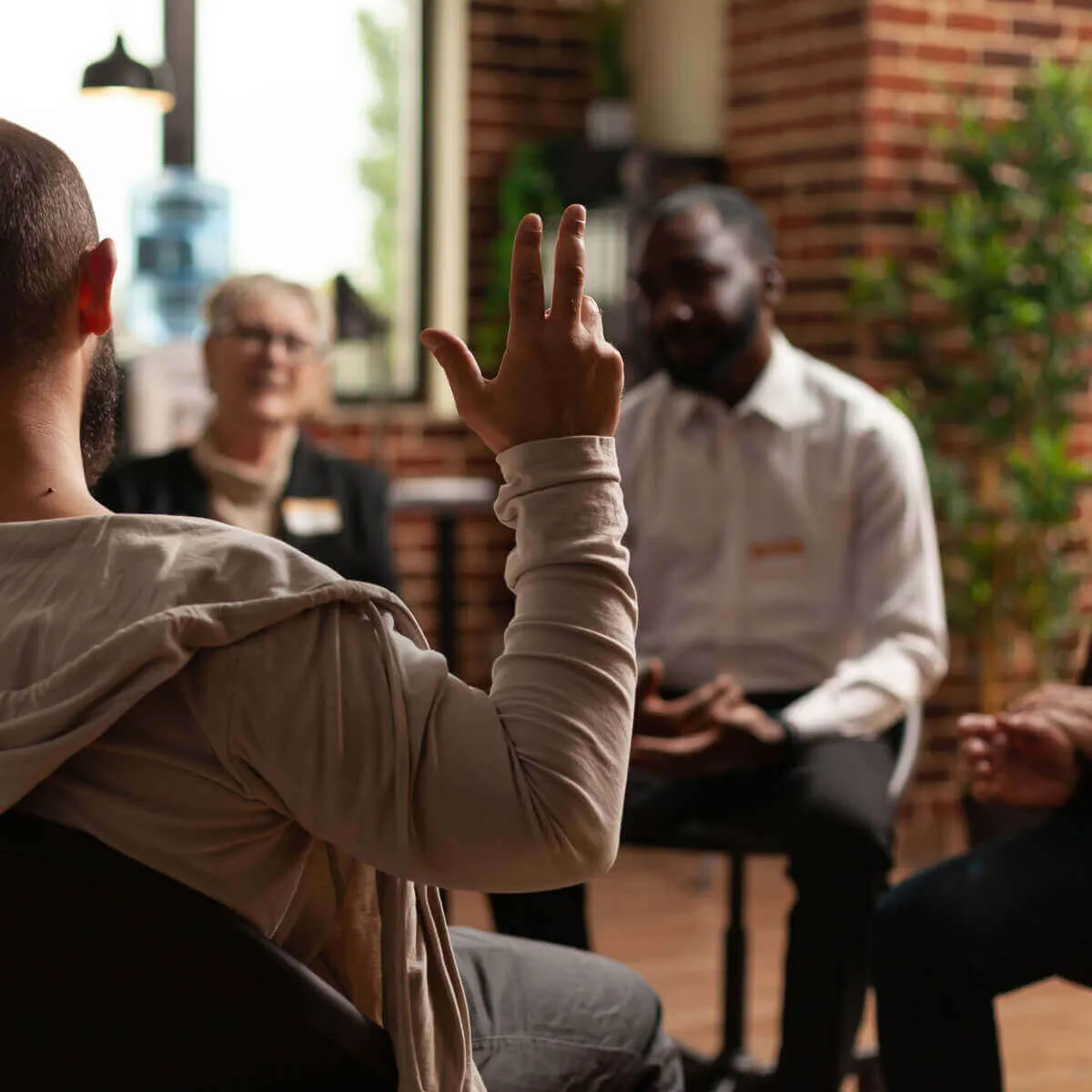 Man raising his hand to talk